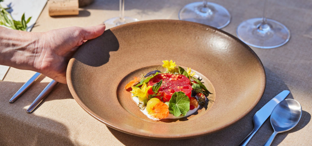 dinner plate with tomatoes and seasonal herbs