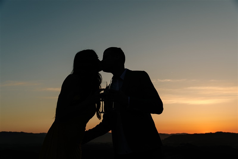 silhouette image of a couple kissing at sunset