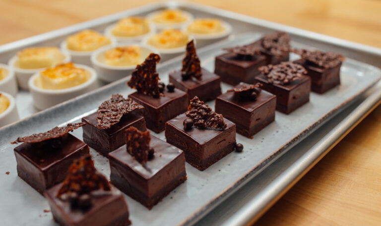 close-up photo of a tray of chocolate tortes for starlight supper dessert course