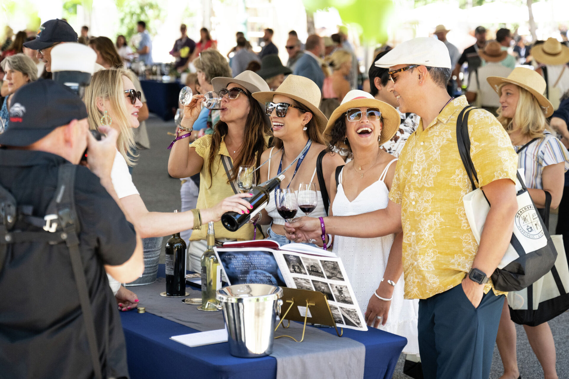 guests at outdoor event wine tasting booth