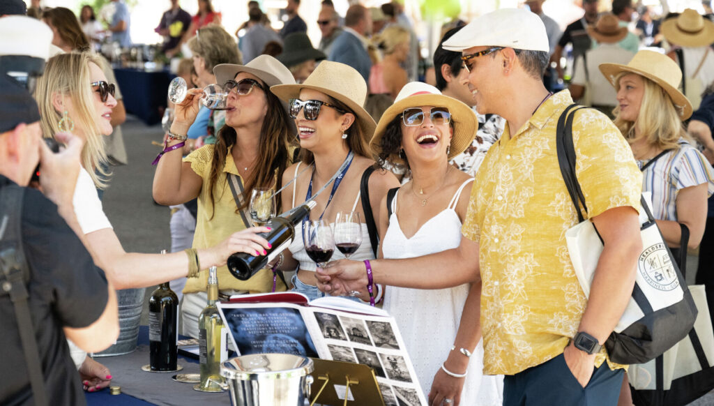 guests at outdoor event wine tasting booth