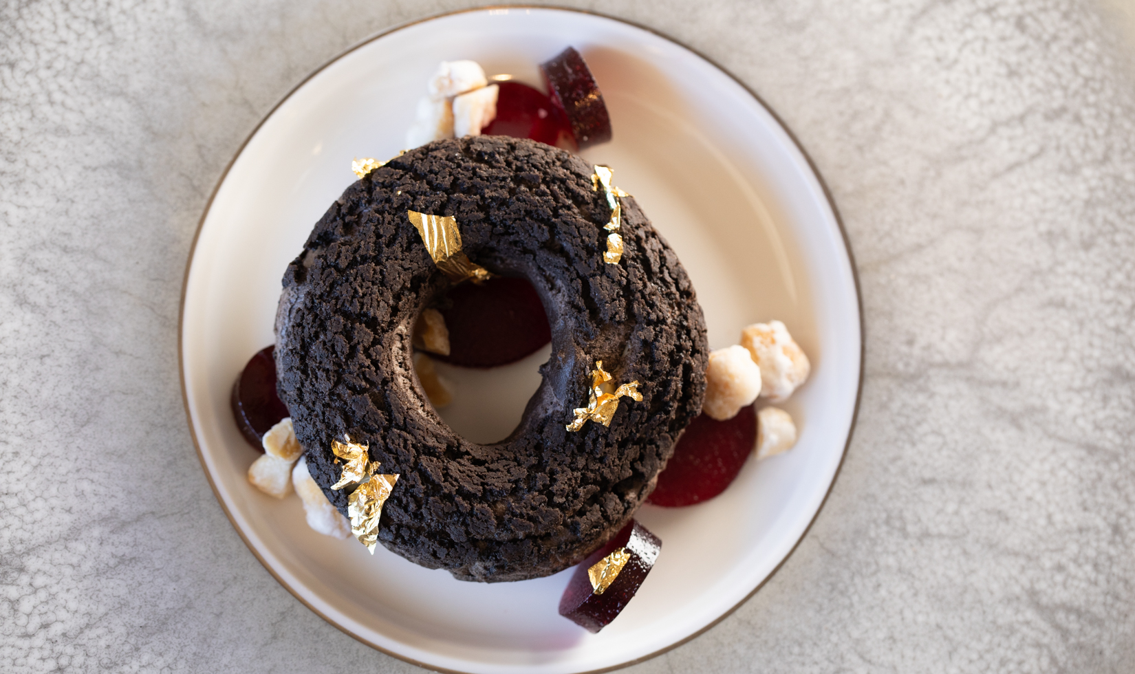 chocolate dessert shaped in a round ring on a white plate