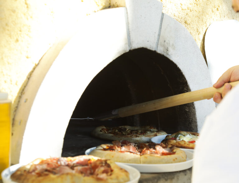 pizzas going to pizza oven