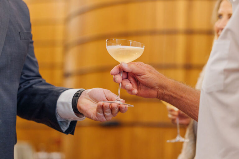 sommelier handing a glass of champagne to a guest