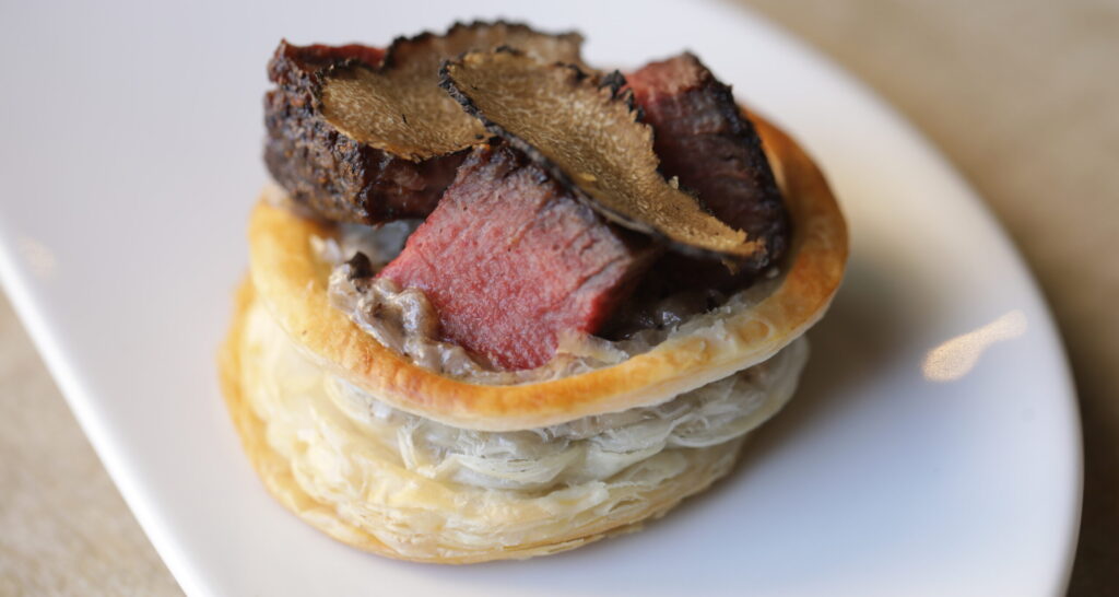 Beef wellington food pariing on white plate