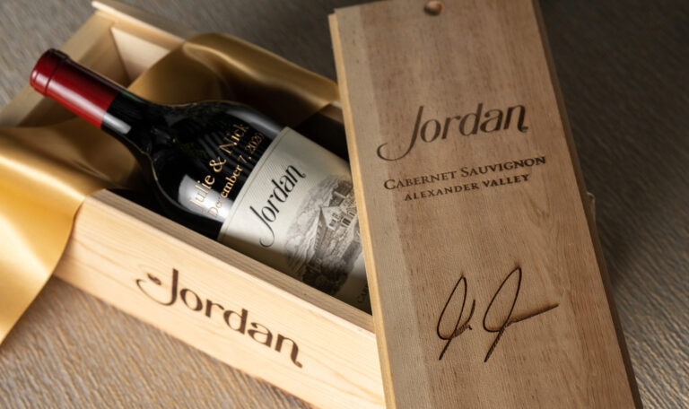 Engraved bottle of Jordan Cabernet Sauvignon in wooden box with gold ribbon